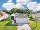 Charming single-story home with well-manicured lawn and attached two-car garage at 27510 Discover Ct, Leesburg, FL 34748