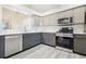 Bright kitchen featuring stainless steel appliances, gray cabinets, and white countertops at 27510 Discover Ct, Leesburg, FL 34748