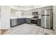 Modern kitchen with stainless steel appliances and gray shaker cabinets at 27510 Discover Ct, Leesburg, FL 34748
