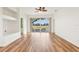 Bright living room with wood floors and sliding glass doors leading to the outside at 27510 Discover Ct, Leesburg, FL 34748