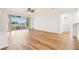 Spacious living room featuring hardwood floors and sliding glass doors at 27510 Discover Ct, Leesburg, FL 34748