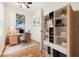 Office space featuring wood floors, desk, shelves, and window with a view at 27510 Discover Ct, Leesburg, FL 34748
