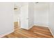 Room featuring wood floors and an open door at 27510 Discover Ct, Leesburg, FL 34748