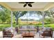 Bright sunroom with ceiling fan, lovely seating area, and a scenic view of the exterior landscape at 27510 Discover Ct, Leesburg, FL 34748