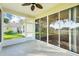 Enclosed sunroom with ceiling fan and sliding glass doors leading to an outdoor view at 27510 Discover Ct, Leesburg, FL 34748