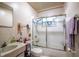 Functional bathroom features a tiled shower, vanity sink, toilet, and neutral colors at 30011 County Road 437, Sorrento, FL 32776