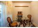 Cozy dining area with a glass table and wicker chairs, illuminated by natural light at 30011 County Road 437, Sorrento, FL 32776