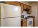 Well-equipped kitchen featuring a full-size refrigerator and an electric range at 30011 County Road 437, Sorrento, FL 32776