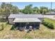 Rear view of home featuring a screened-in patio with an assortment of plants and outdoor features at 30011 County Road 437, Sorrento, FL 32776