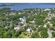 An aerial view showcases neighborhood homes nestled among lush trees, providing a serene, lakeside community at 306 N Clayton St, Mount Dora, FL 32757
