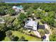 Aerial view of a beautiful property with lush greenery, well-maintained lawns, and a private driveway at 306 N Clayton St, Mount Dora, FL 32757