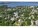 An aerial view showcases neighborhood homes nestled among lush trees, providing a serene, lakeside community at 306 N Clayton St, Mount Dora, FL 32757