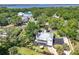 Aerial view of a home featuring lush greenery, nearby bodies of water, and a meticulously kept yard at 306 N Clayton St, Mount Dora, FL 32757