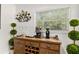 An indoor bar area with custom cabinets, modern appliances, and a wine rack with glasses at 306 N Clayton St, Mount Dora, FL 32757