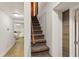 Carpeted basement stairs lead to an open area and a tiled floor kitchen at 306 N Clayton St, Mount Dora, FL 32757