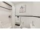 Bathroom featuring tiled walls and floors, and modern fixtures at 306 N Clayton St, Mount Dora, FL 32757