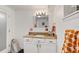 Well-lit bathroom featuring a granite countertop vanity, modern mirror, and stylish fixtures at 306 N Clayton St, Mount Dora, FL 32757