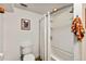 Bathroom featuring a toilet, shower-tub combination with a white shower curtain at 306 N Clayton St, Mount Dora, FL 32757