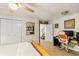 Bedroom showcasing a closet, ceiling fan, desk, and a cozy bed with soft, neutral bedding at 306 N Clayton St, Mount Dora, FL 32757