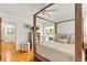 Well-lit bedroom featuring a four-poster bed, hardwood floors, and a view of the outdoor patio at 306 N Clayton St, Mount Dora, FL 32757