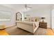 A bedroom featuring a large bed, multiple pillows, hardwood floors and a sliding door to the outside at 306 N Clayton St, Mount Dora, FL 32757