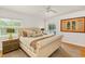 A bedroom featuring a large bed, multiple pillows, hardwood floors and a sliding door to the outside at 306 N Clayton St, Mount Dora, FL 32757