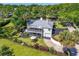 Charming two-story home featuring a screened porch, attached garage, and beautiful landscaping at 306 N Clayton St, Mount Dora, FL 32757