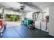 Spacious garage featuring laundry machines, storage cabinets, an open garage door, and lawn equipment at 306 N Clayton St, Mount Dora, FL 32757