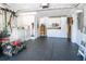 Organized garage space featuring epoxy floor, laundry area, cabinets, and ample storage for tools and equipment at 306 N Clayton St, Mount Dora, FL 32757