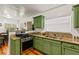 Bright kitchen featuring granite countertops, modern stainless-steel appliances, and hardwood floors at 306 N Clayton St, Mount Dora, FL 32757
