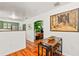Open-concept dining area leading to a kitchen with stainless steel appliances and green cabinetry at 306 N Clayton St, Mount Dora, FL 32757