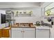 Kitchenette features white cabinets, appliances and countertop, with a sink and a stove at 306 N Clayton St, Mount Dora, FL 32757