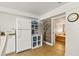 Kitchenette with stainless steel appliances, shelving, and view to an adjacent bedroom at 306 N Clayton St, Mount Dora, FL 32757