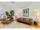 Inviting living room features stylish leather furniture, hardwood floors, and sophisticated decor at 306 N Clayton St, Mount Dora, FL 32757