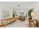 Bright, open living area with multiple seating areas and large windows bringing in natural light at 306 N Clayton St, Mount Dora, FL 32757