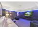 Modern media room features a large screen and soundproofing panels at 306 N Clayton St, Mount Dora, FL 32757