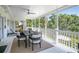 Screened porch with dining table and chairs offers views of lush greenery at 306 N Clayton St, Mount Dora, FL 32757
