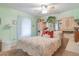 Bedroom featuring light green walls, built-in storage, and a ceiling fan at 3075 Cr 431N, Lake Panasoffkee, FL 33538