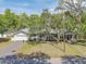 Charming single-story home with lush landscaping, driveway, and cozy entrance at 3075 Cr 431N, Lake Panasoffkee, FL 33538
