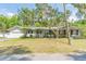 Charming single-story home with attached garage, mature landscaping and a well-manicured lawn at 3075 Cr 431N, Lake Panasoffkee, FL 33538