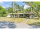 Charming single story home with a covered porch, walkway, and mature landscaping at 3075 Cr 431N, Lake Panasoffkee, FL 33538