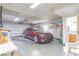 Spacious two car garage with car, overhead lighting, and a workbench at 3075 Cr 431N, Lake Panasoffkee, FL 33538