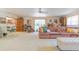 Spacious living room features neutral carpeting, a ceiling fan and natural light from large windows at 3075 Cr 431N, Lake Panasoffkee, FL 33538