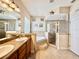Elegant bathroom with double sinks, a soaking tub, and glass-enclosed shower at 31728 Nutmeg Ave, Eustis, FL 32736