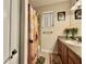 Bathroom features a single sink vanity, large mirror, decorative sunflower accents, and tiled shower at 31728 Nutmeg Ave, Eustis, FL 32736