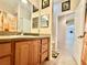 Bathroom featuring wood cabinets, tiled floor and shower, and neutral wall color at 31728 Nutmeg Ave, Eustis, FL 32736