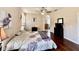 Spacious bedroom with hardwood floors, a ceiling fan, and ensuite bathroom access at 31728 Nutmeg Ave, Eustis, FL 32736