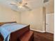 Bedroom with wooden floors featuring a bed, a chest and ample wall space at 31728 Nutmeg Ave, Eustis, FL 32736
