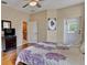 Bright bedroom with hardwood floors, ceiling fan, and door to the backyard at 31728 Nutmeg Ave, Eustis, FL 32736