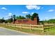 The entrance to Royal Trails, a deed-restricted community, marked by a brick sign and wooden fence at 31728 Nutmeg Ave, Eustis, FL 32736
